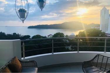 Living room with floor-to-ceiling windows, ocean views, and balcony at Casa Bonita Playa Bonita Panama