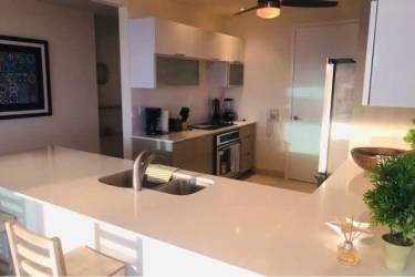 Contemporary kitchen with large white island and built-in appliances Casa Bonita Playa Bonita Panama