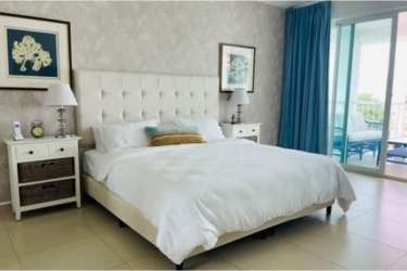 Master bedroom with king bed, large windows and ensuite bathroom oceanfront condo at Bijao Panama