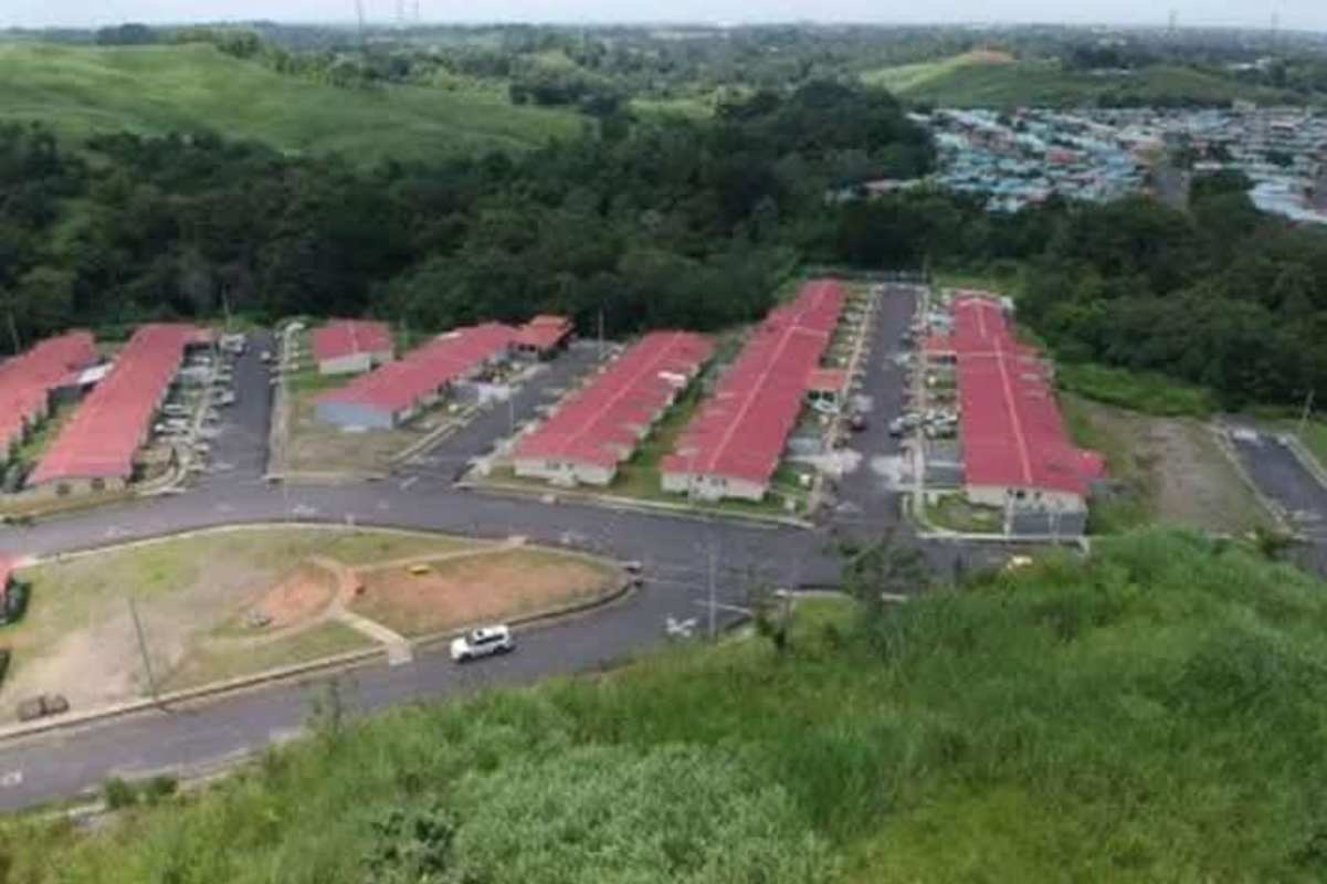 Residential neighborhood with red rooftops adjacent available land Pedregal Villalobos Panama