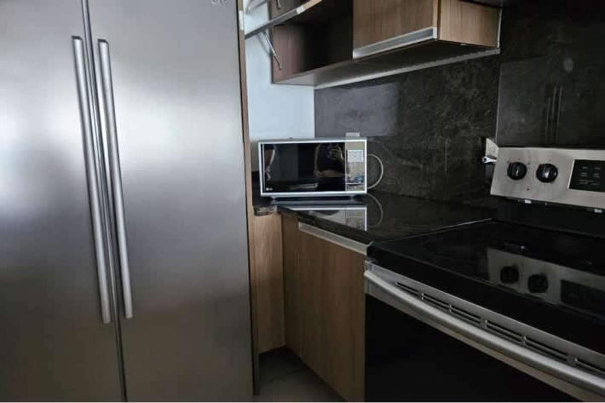 Contemporary kitchen granite countertops stainless appliances PH Rivage Panama apartment rental