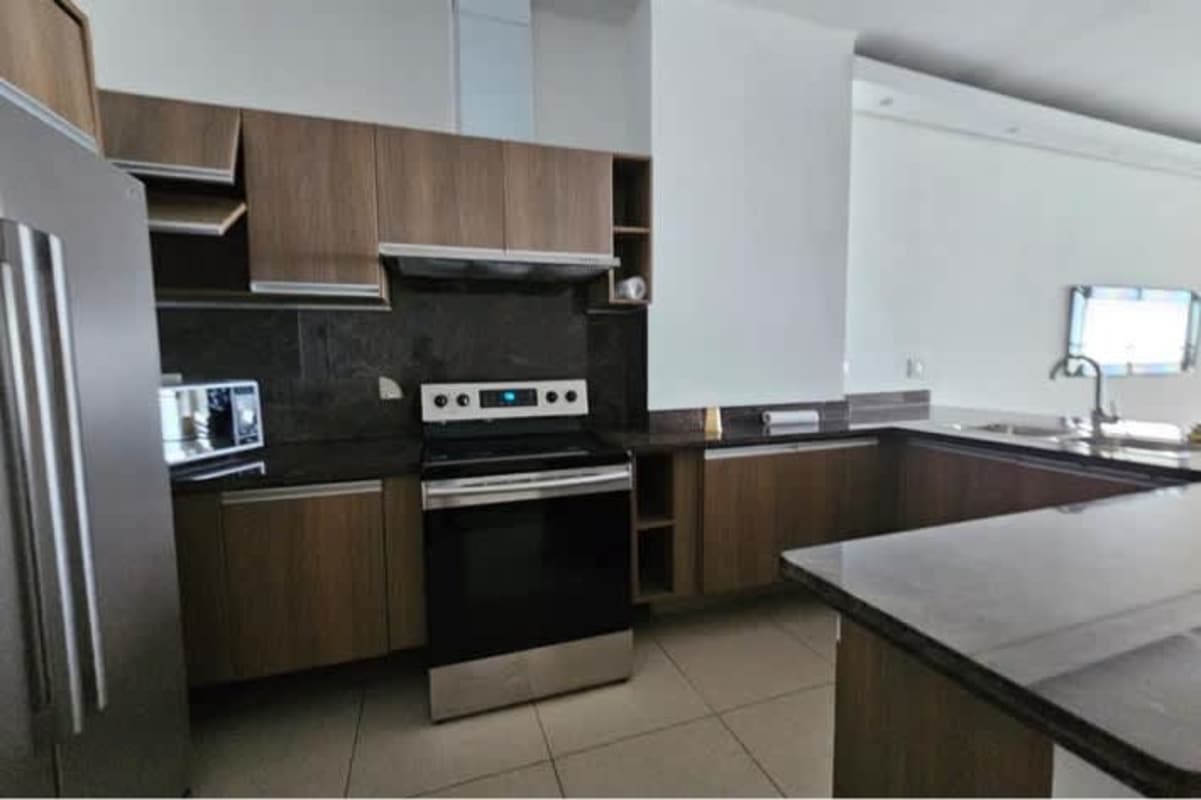 Open kitchen with granite countertops, stainless steel refrigerator, oven, microwave PH Rivage Tower Panama