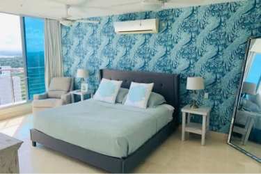 Guest bedroom with panoramic Canal and Pacific Ocean view in Casa Bonita penthouse Panama