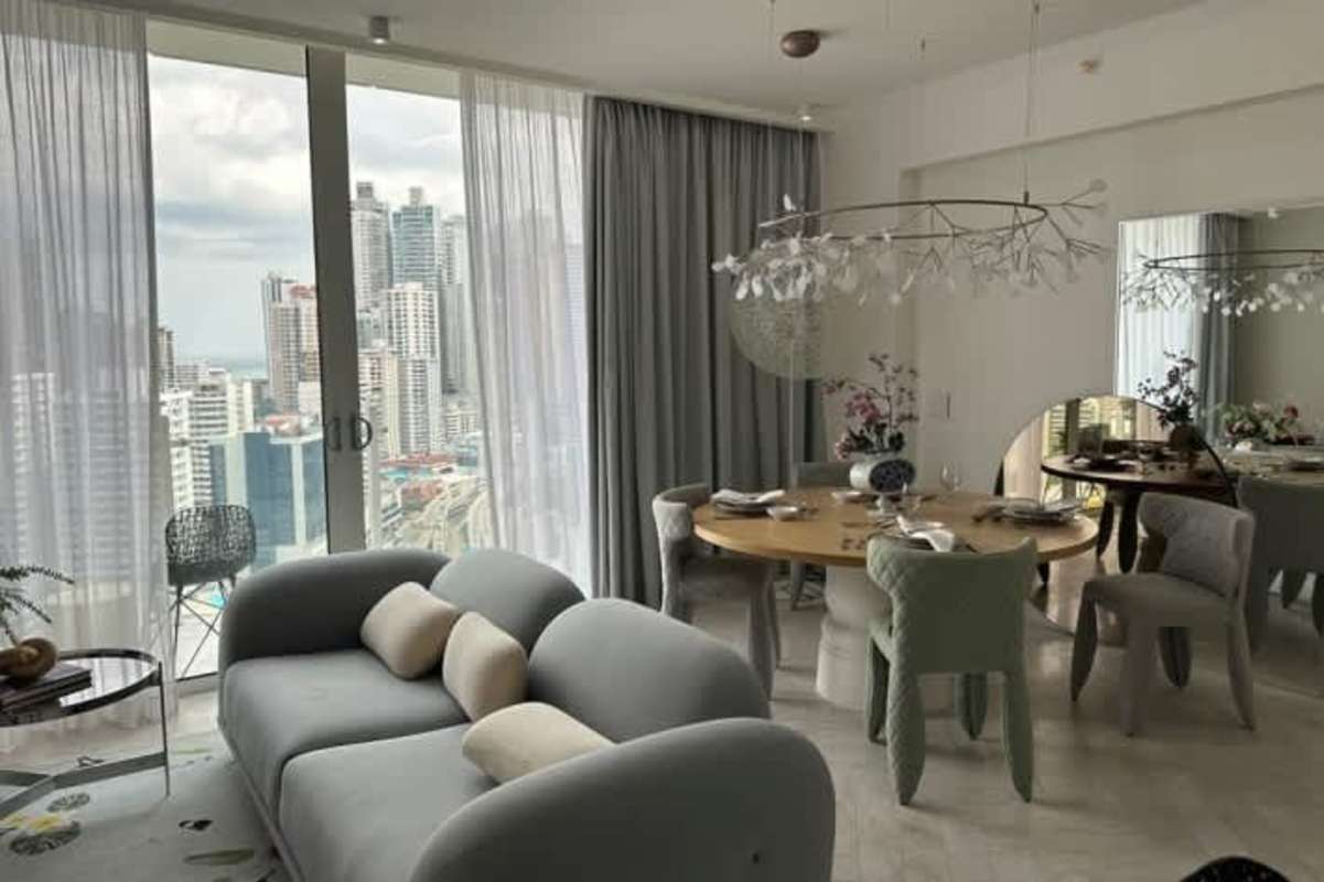 Elegant living dining space with large windows panoramic city views in Wanders Yoo Panama