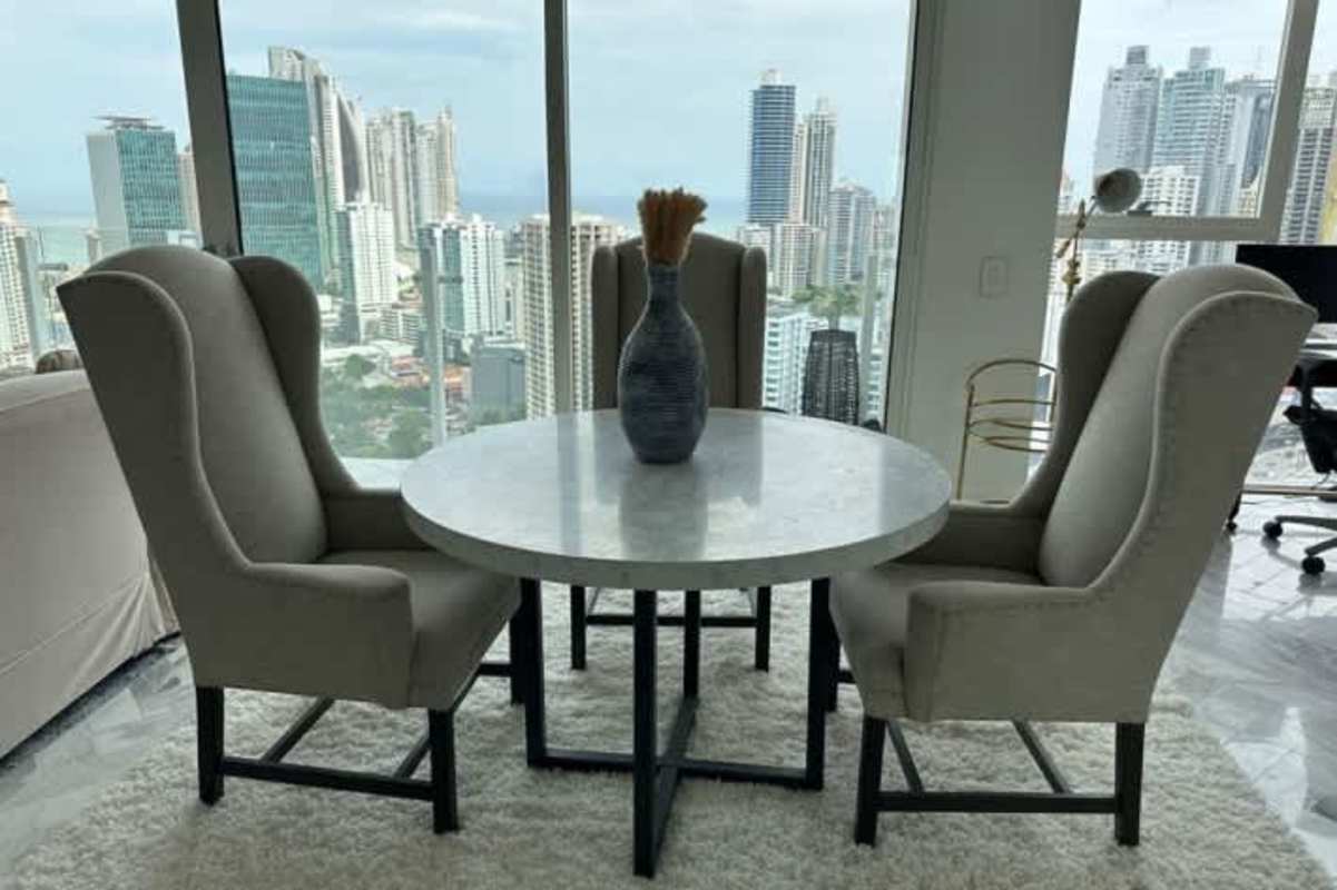 Dining area with panoramic city views and marble table Wanders Yoo Panama City