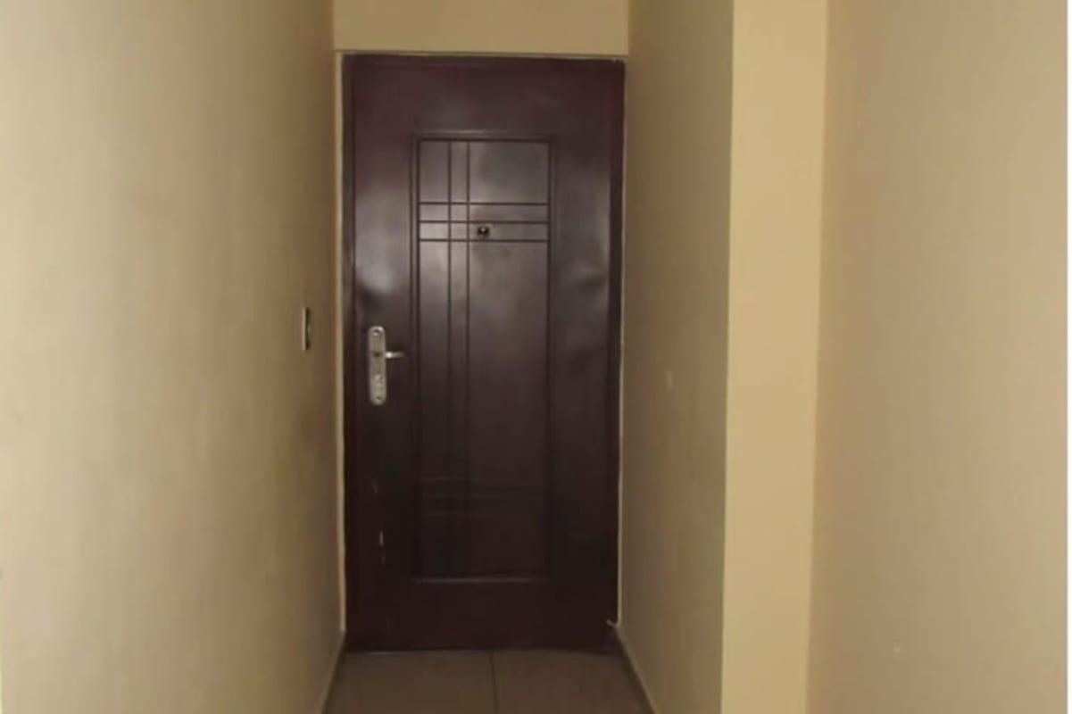 Entrance hallway with secure wooden door inside Terrazas del Rey Condado del Rey Panama apartment