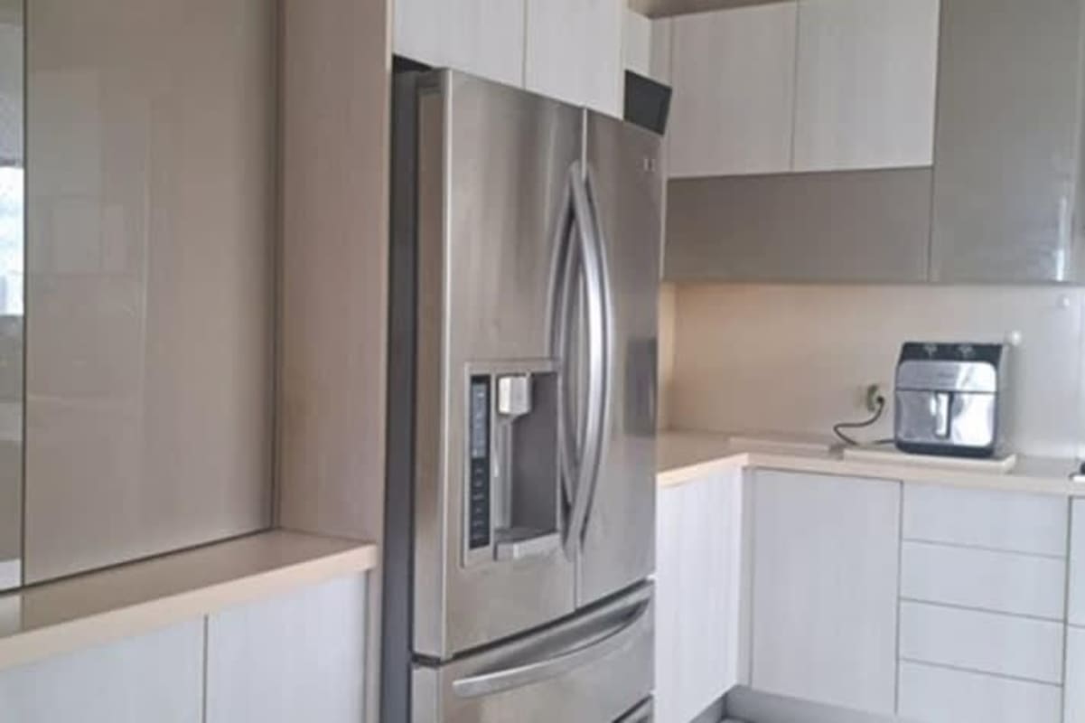 Contemporary kitchen with island, quartz countertop, stainless appliances in PH Vista del Mar Panama City