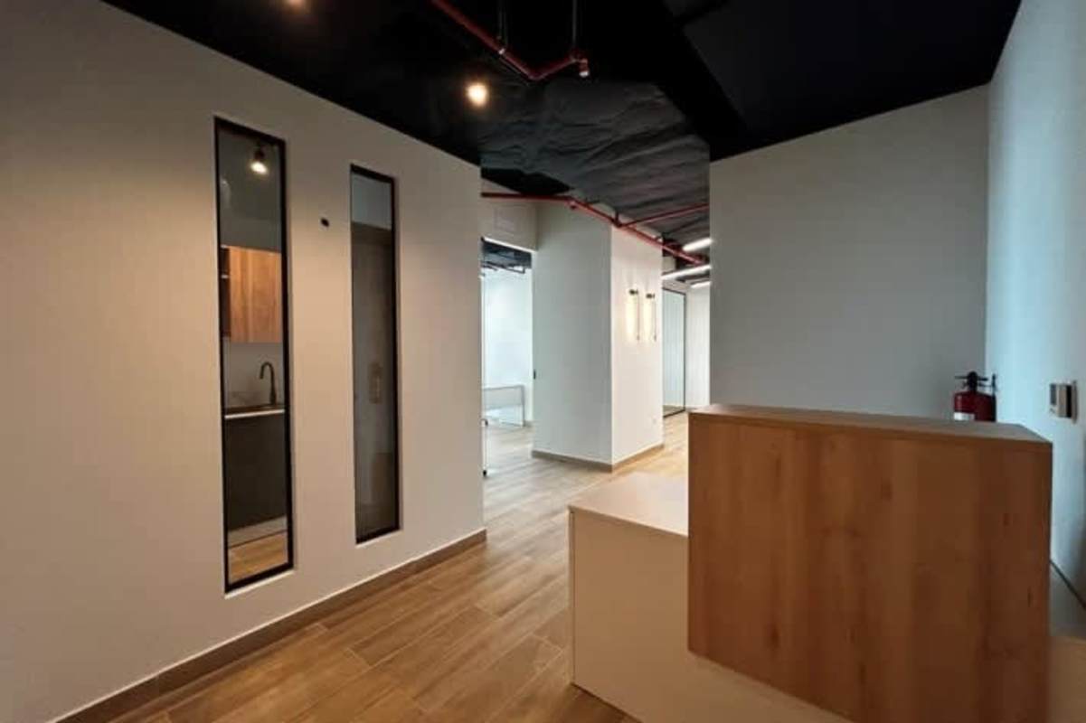 Compact office kitchenette with marble counter adjacent bathroom modern decor Panama