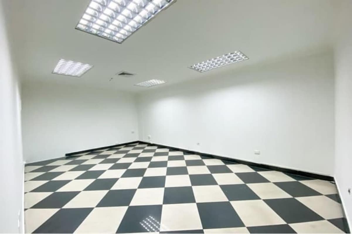 Empty office with fluorescent lighting, tile flooring at PH BICSA Tower in Obarrio Panama City