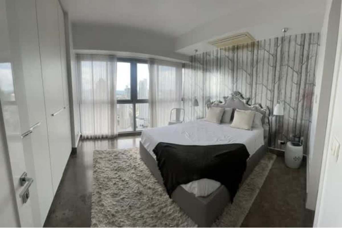 Spacious living room with large windows, contemporary furnishing, ocean view in luxury condo PH Yoo Panama