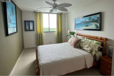 Bright bedroom with ceiling fan, wooden bed, ocean view window in PH El Peñón de Farallón