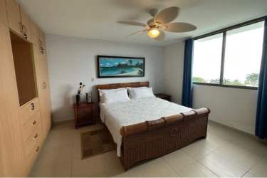 Primary bedroom with window, ceiling fan, coastal decor in PH El Peñón de Farallón Panama