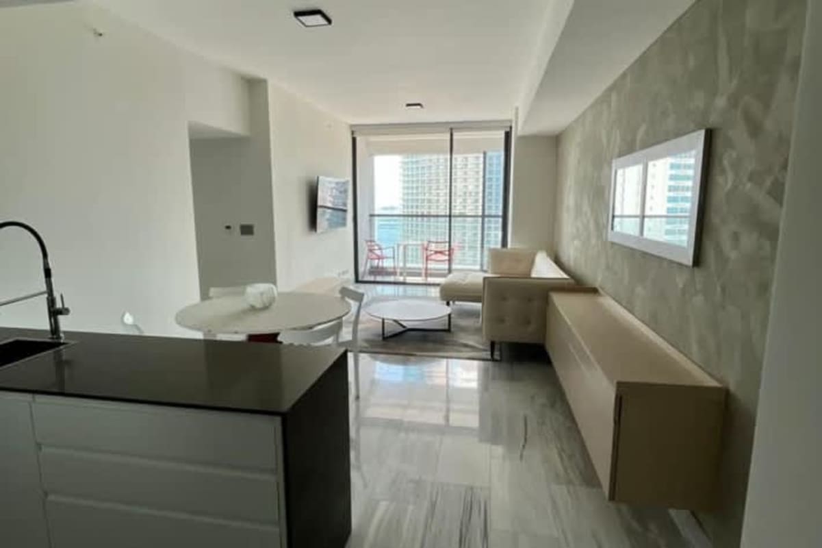 Bright open-plan living dining with balcony city view Nuovo Residences Bella Vista