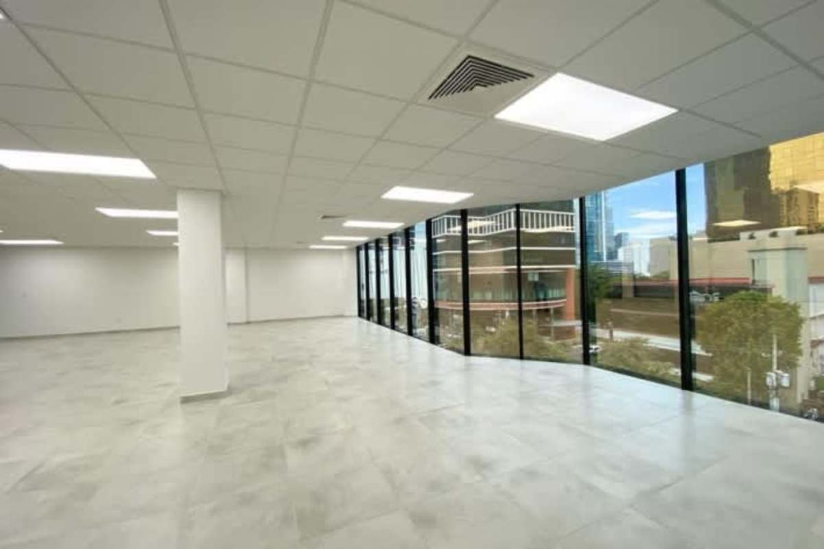 Commercial office space with tile floors, large windows, white walls in financial district Panama