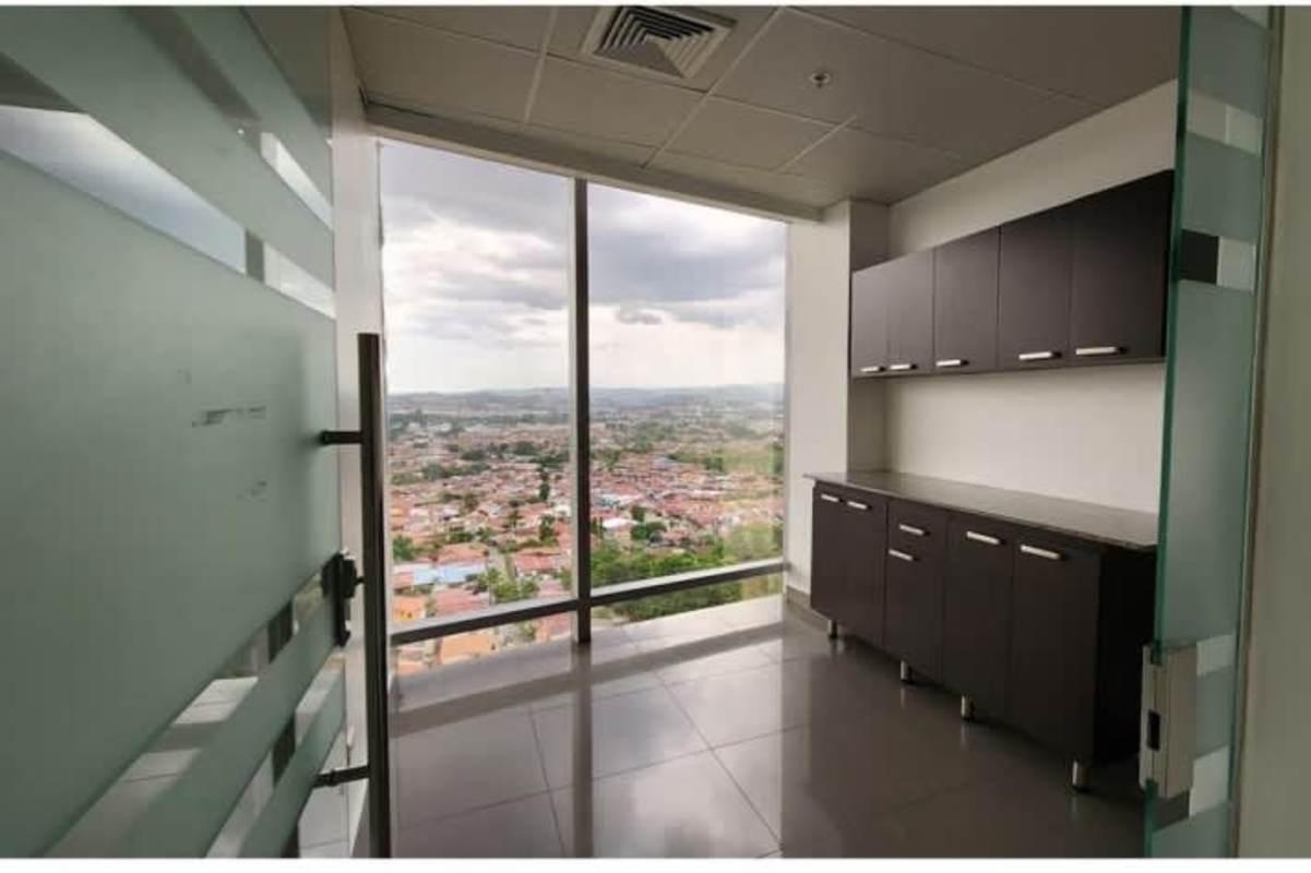 Modern kitchenette space in commercial tower with large window view in PH Aseguradora Ancón Panama