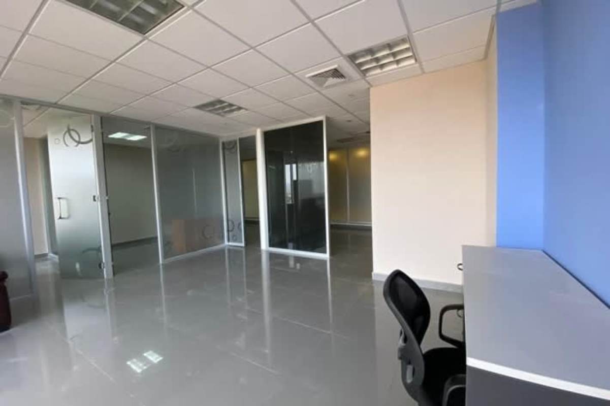 View inside modern private office with glass partition walls in Torre Aseguradora Ancón Costa del Este Panama