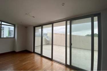 Modern kitchen with ample cabinets, granite counters, window view in PH Midrise Panama Pacifico