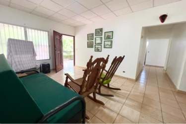 Small structure with water tank and pickup truck on property yard