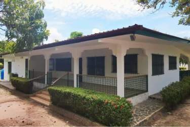 Accessible Coronado single-family home with porch, hedges, garden