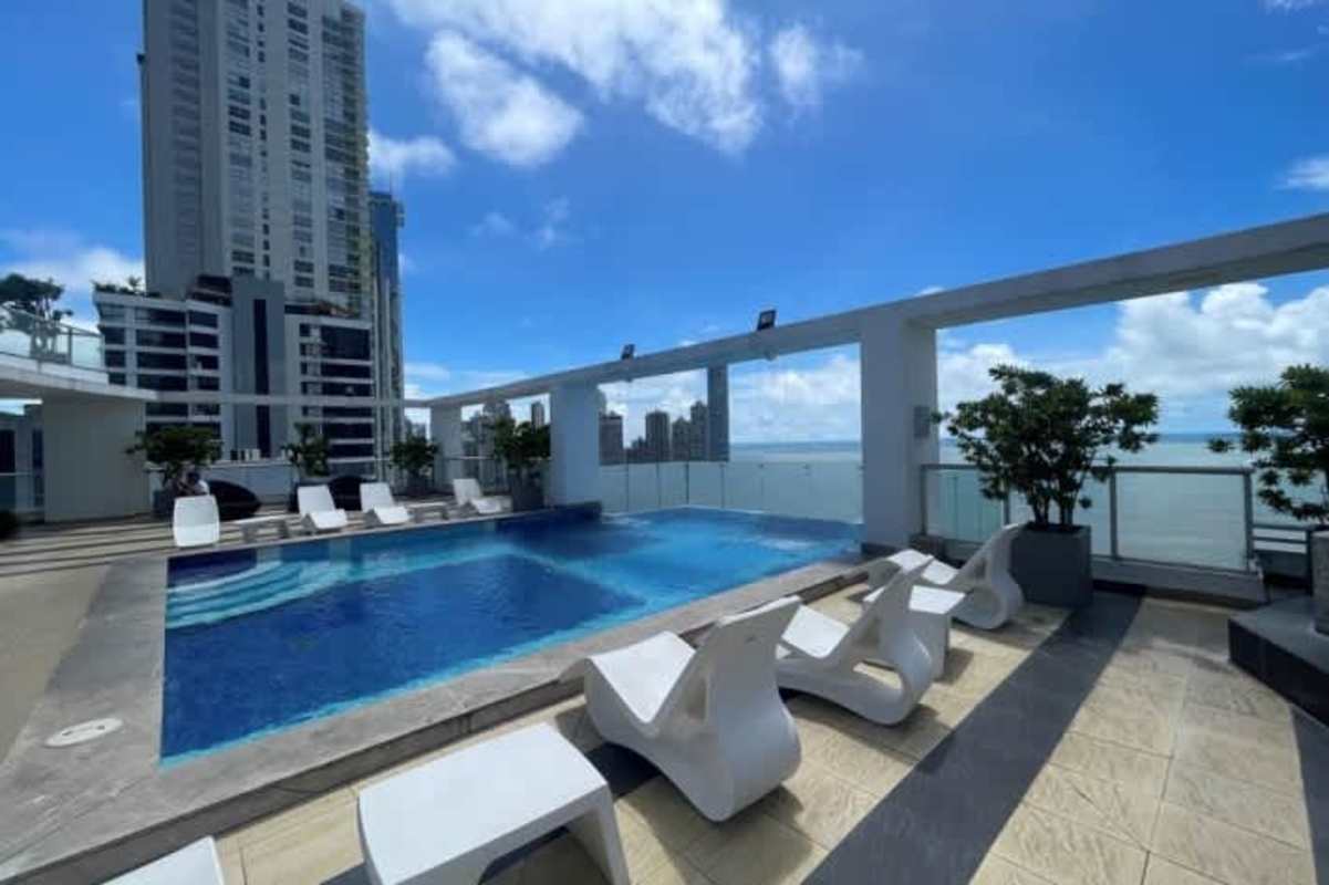 Rooftop infinity pool, lounge chairs, skyline, ocean views at Villa del Mar Panama