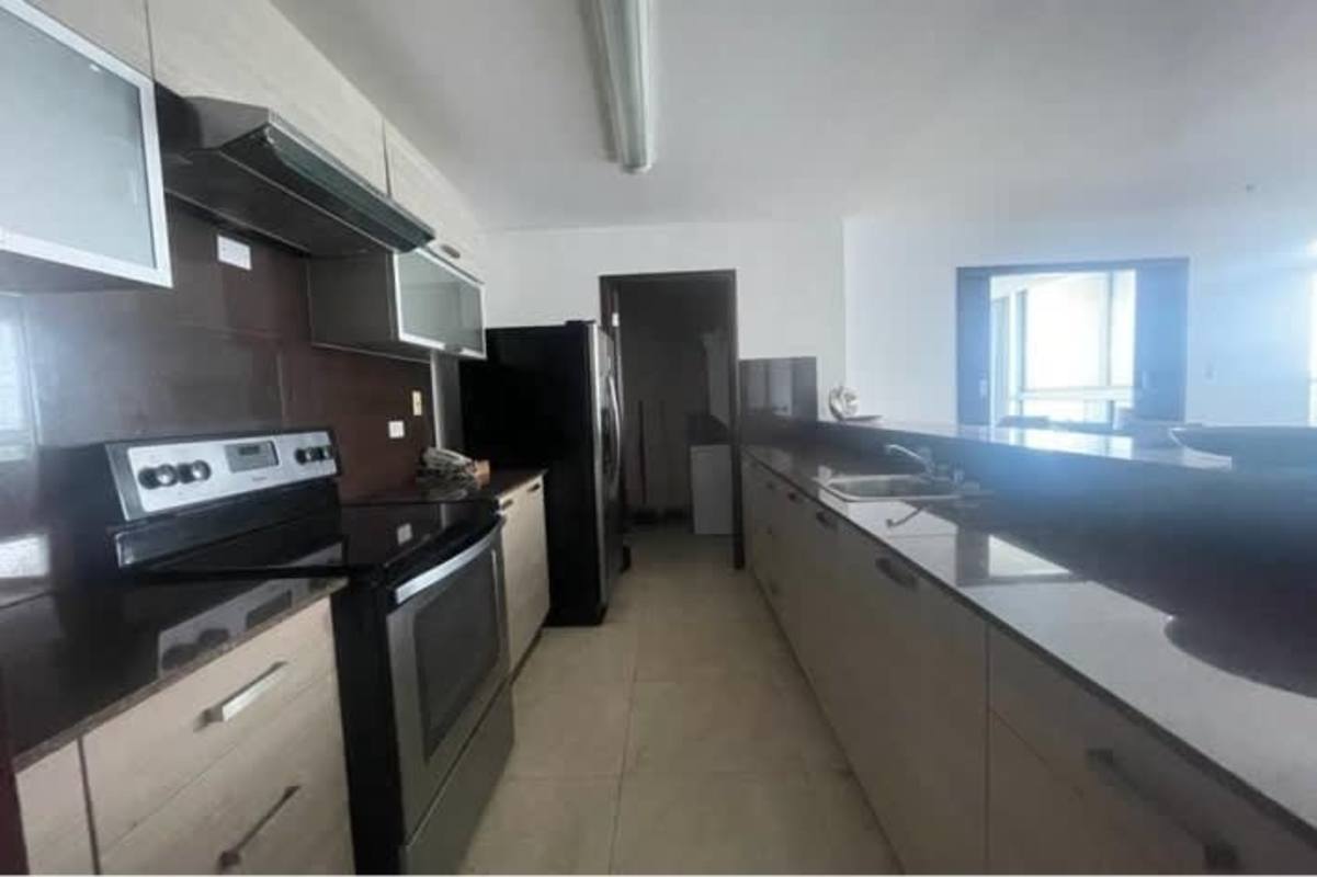 Galley kitchen with stainless appliances granite countertops PH Villa del Mar Avenida Balboa Panama