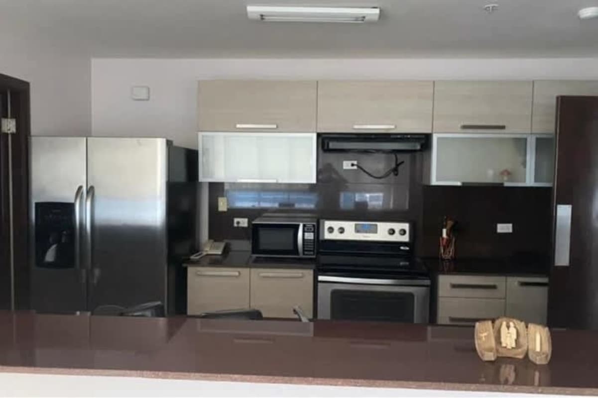 Kitchen with appliances, overhead cabinets and quartz countertop PH Villa del Mar