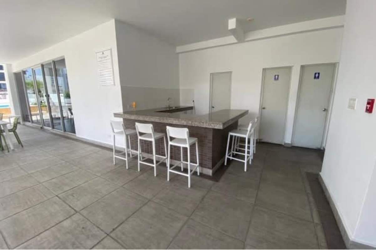 Covered lounge area with bar counter and seating at PH El Cangrejo Panama