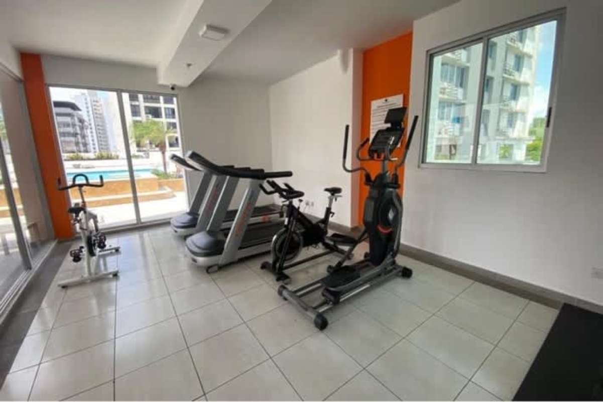 Apartment gym with cardio equipment and pool view at PH El Cangrejo Panama