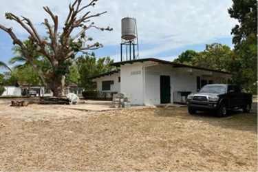 Land lot bordered by street with open flat terrain and tropical greenery in Coronado, Panama beach community