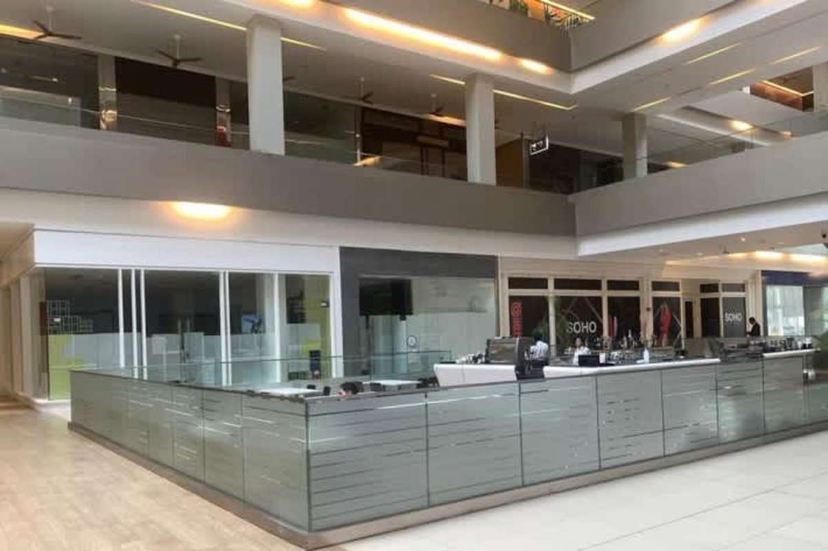 Atrium view with glass railings escalators and retail shops inside Ocean Mall Obarrio Panama