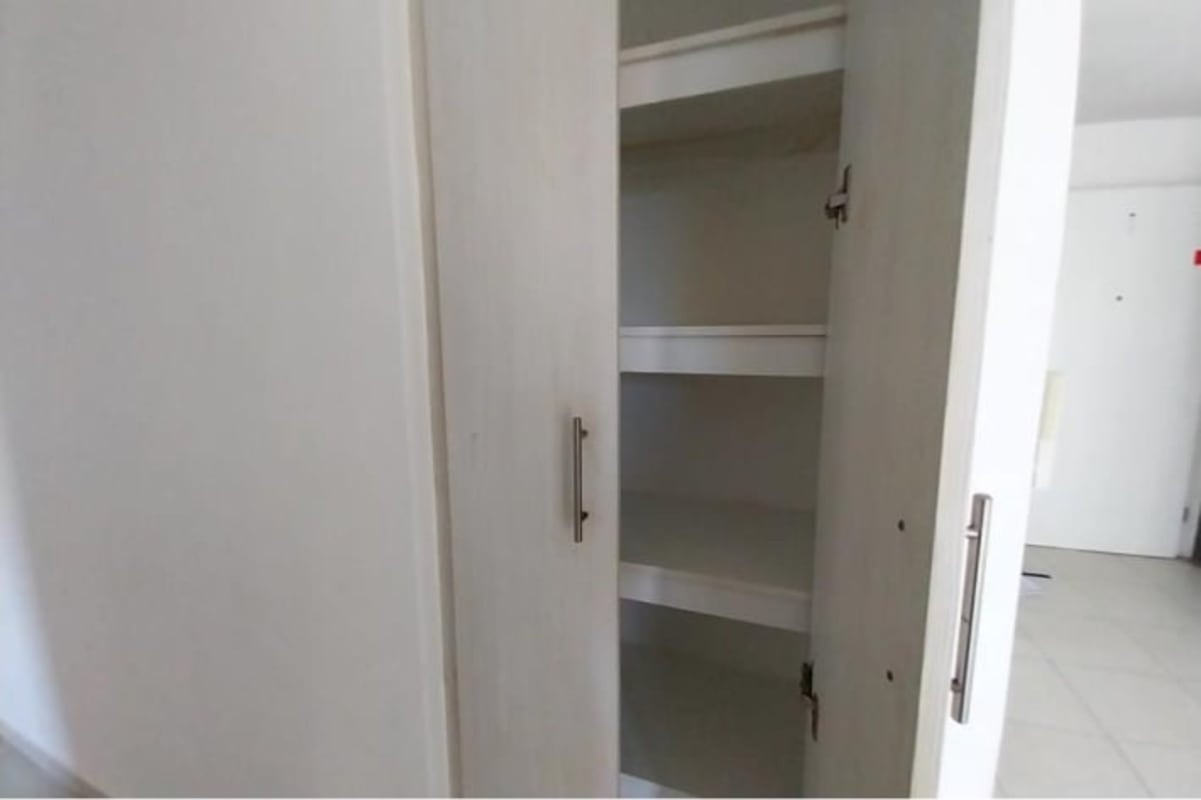 Bedroom with blue accent wall, AC, closet, tile flooring suitable for child, in Versalles Panama City condo