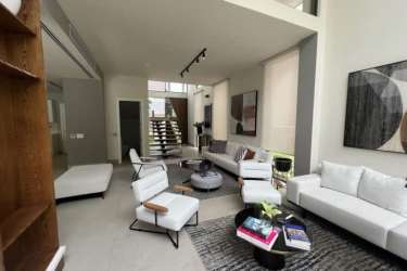 Living room with large windows, open floor plan, contemporary furnishings Explora Panama Pacifico