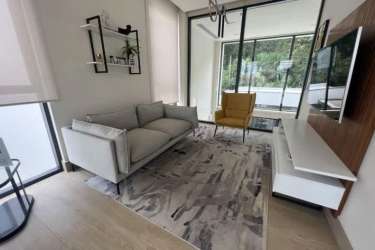 Bedroom with floor-to-ceiling window, city view, modern furnishings Explora Panama Pacifico