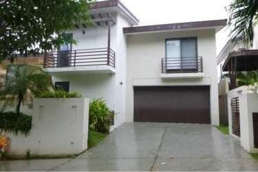 Stylish hallway and staircase with metal railing in luxury Panama Pacifico house