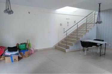 Minimalist living room with floating metal staircase open plan PH River Valley house Panama Pacifico