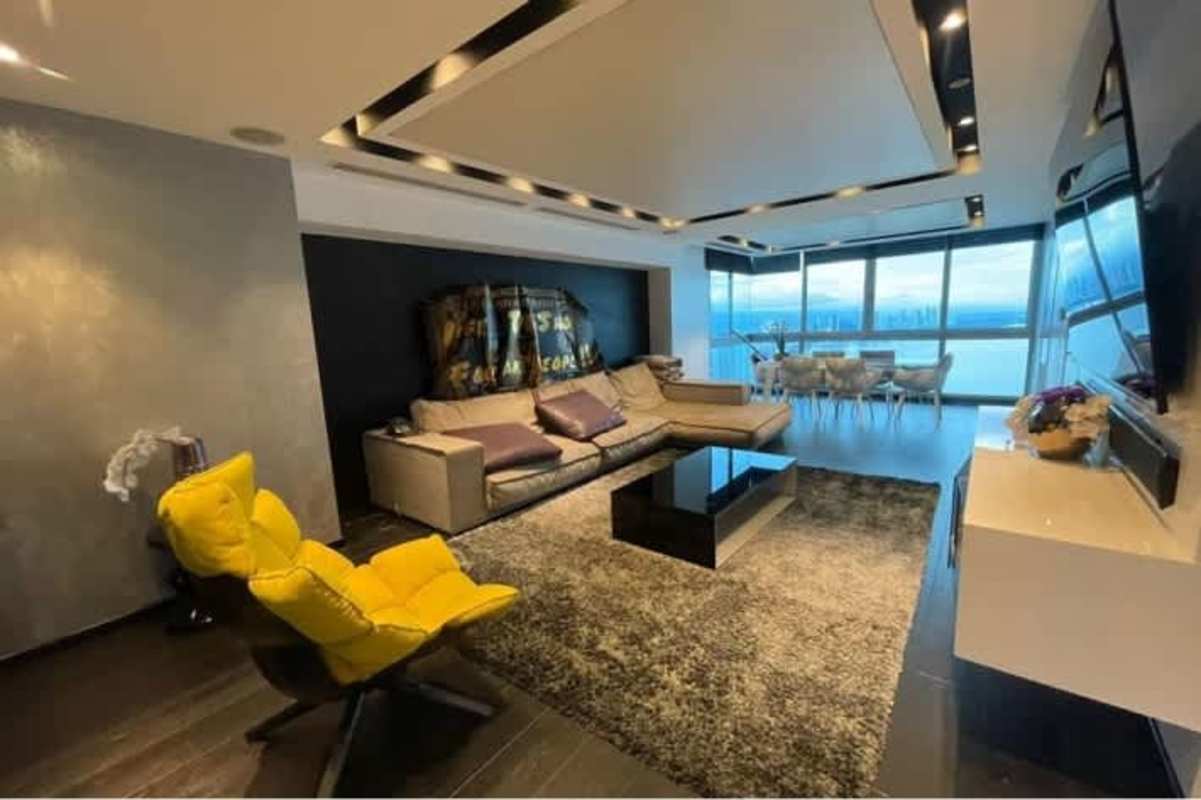 Modern luxury kitchen with granite island, stainless appliances, and ocean view through large windows at PH Aqualina