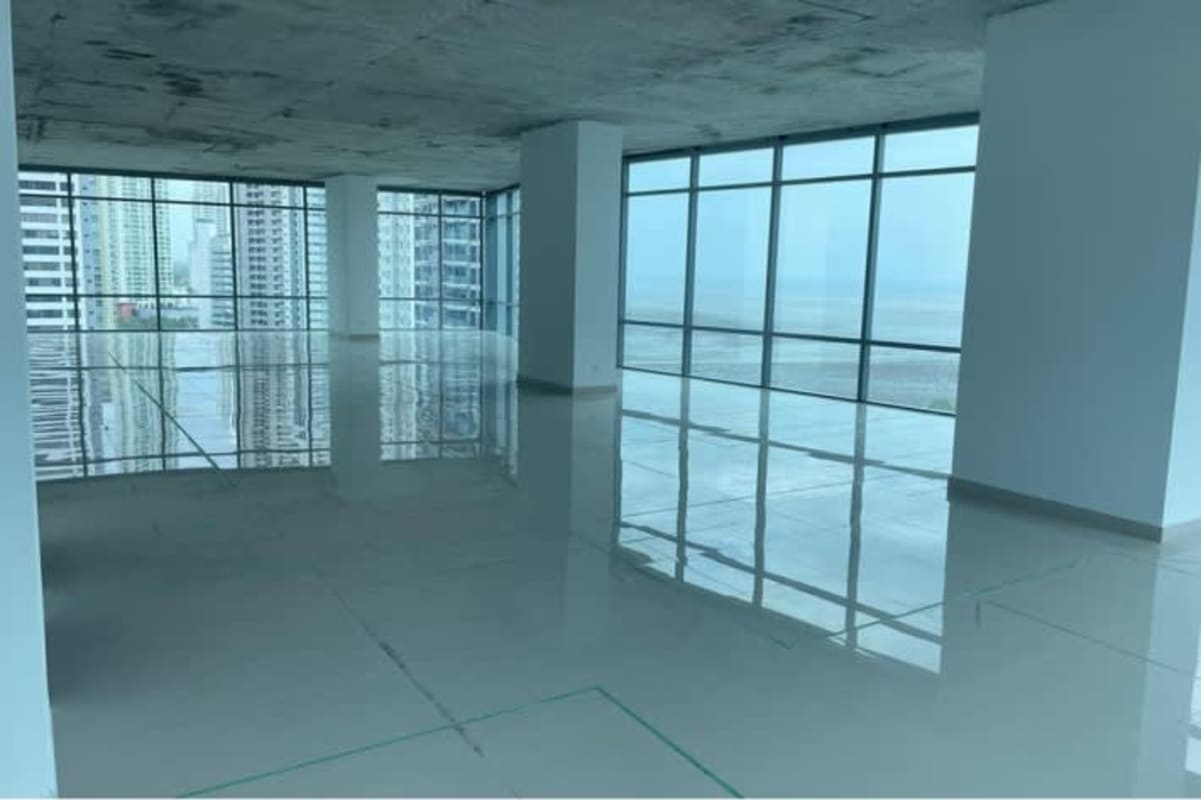 Modern skyscraper glass tower with palm trees coastal Costa del Este Panama City