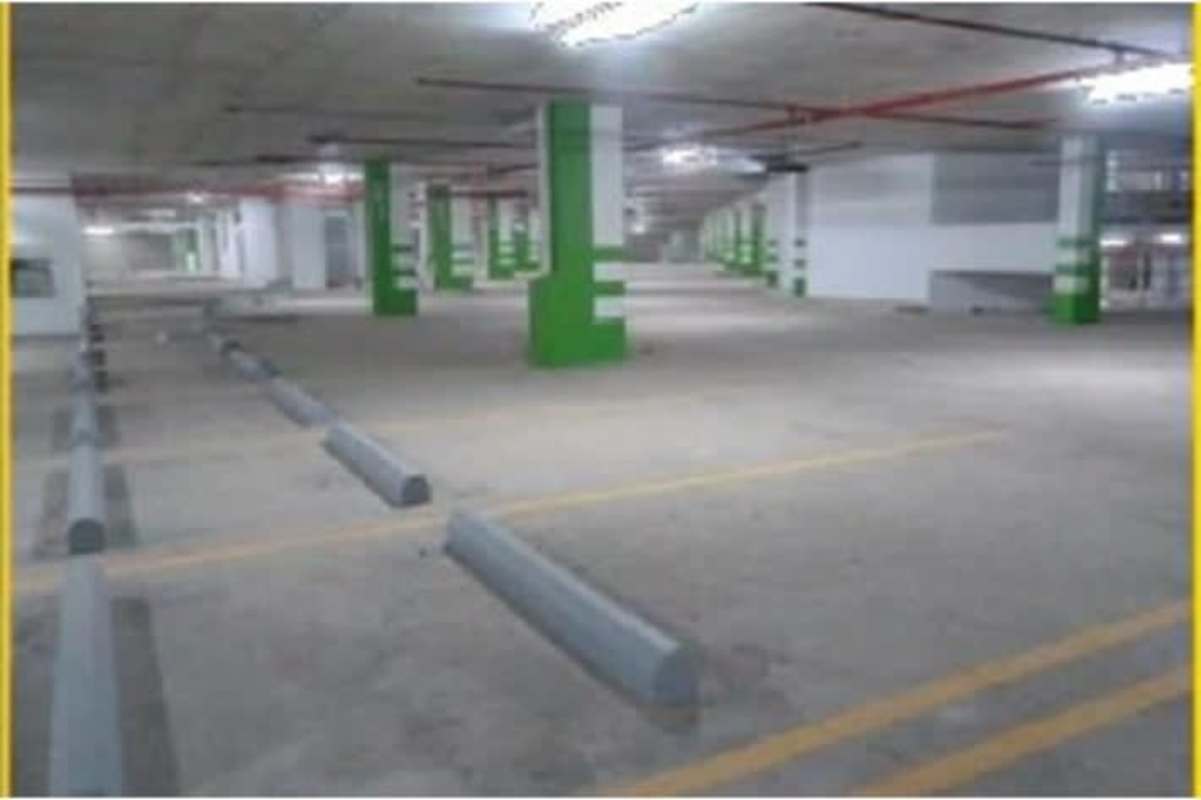Exterior view multi-level commercial complex with parking and glass storefronts Obarrio Panama