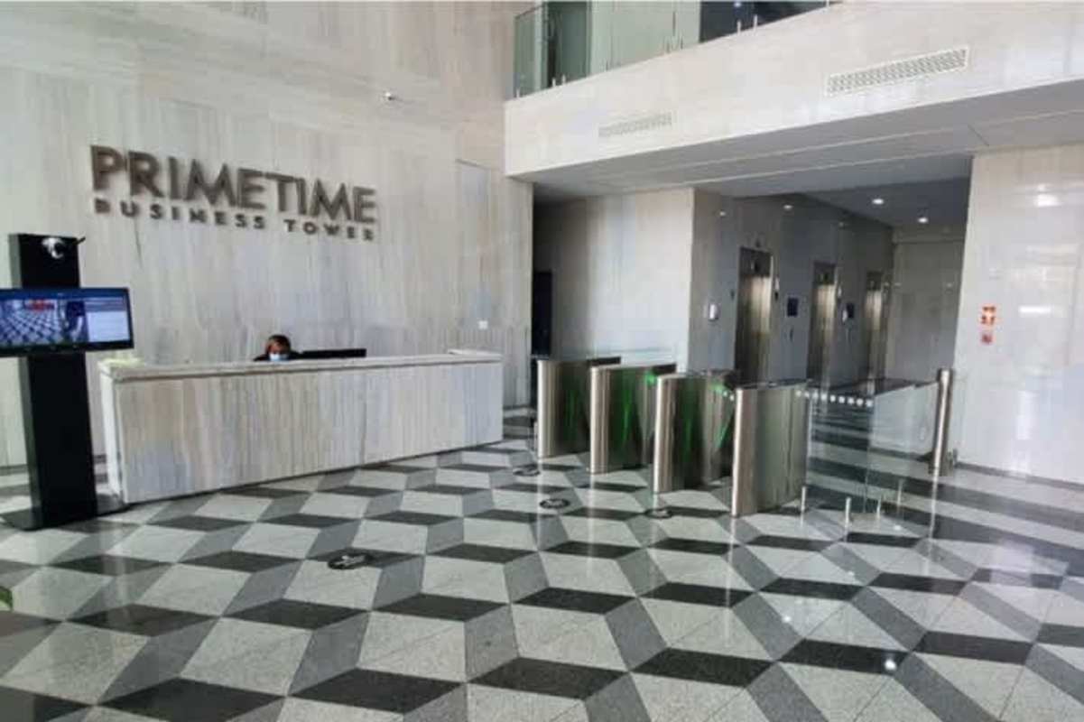 Elegant business tower lobby with security desk elevators geometric floor Prime Time Tower Panama