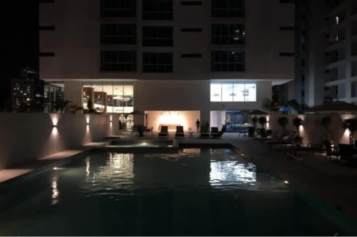 Outdoor swimming pool at night with illuminated lounge at PH The Palace Bella Vista Panama City