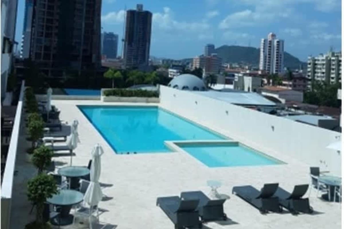 Contemporary living room in penthouse with marble staircase, built-in bookshelf, freestanding bathtub at PH The Palace Bella Vista Panama