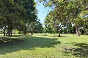 Spacious grassy lot with mature trees inside Coronado Beach Resort Panama