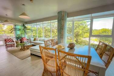Bright living and dining area with garden views PH Punta Barco Village Punta Barco