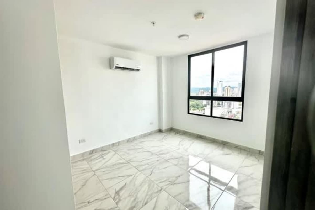 Open plan living and dining space with large windows, marble tile floors, and balcony at PH The Gray Panama City