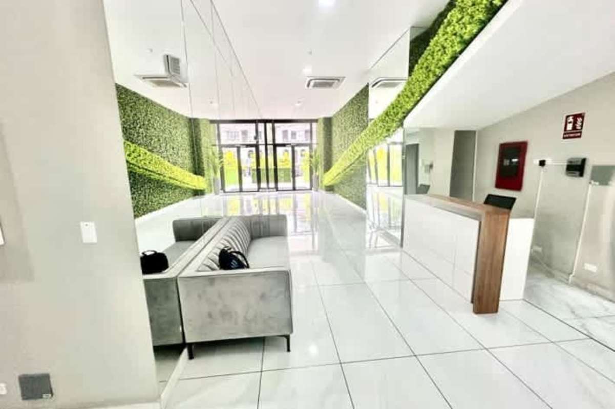 Bright modern kitchen with marble tile floor, sleek cabinetry, appliances space in PH The Gray Panama City