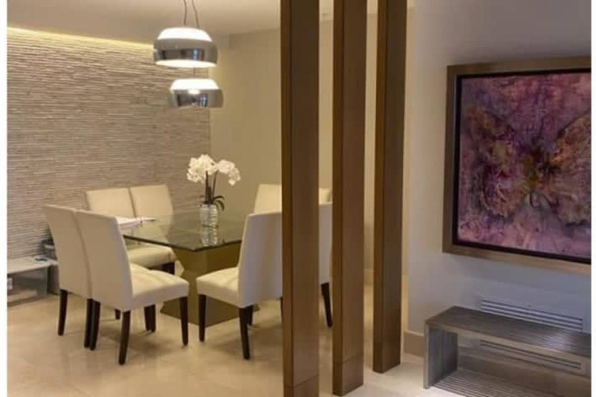 Contemporary dining space with glass table and accent wall PH Paramount Costa del Este Panama