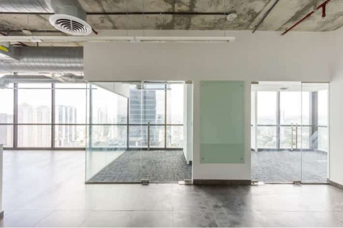 Empty office with glass partitions, floor-to-ceiling windows offering Panama City view at Tower Financial Center