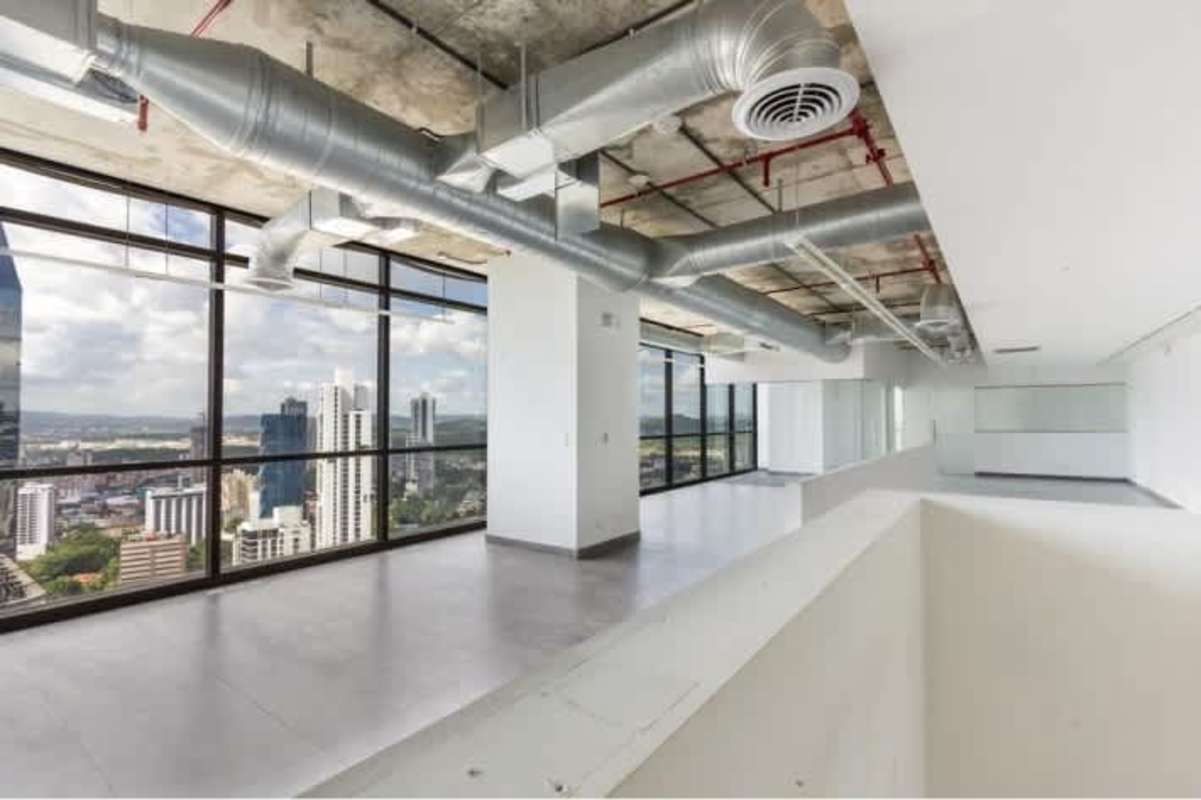 Executive office with exposed ductwork and panoramic Panama City skyline located in Tower Financial Center