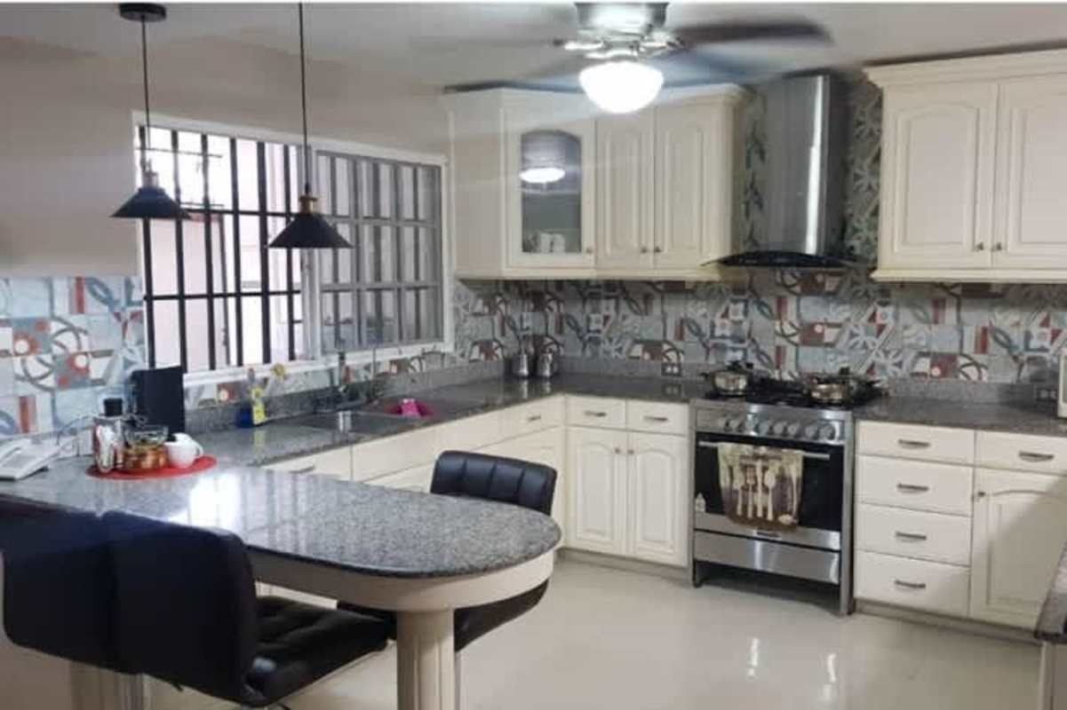 Contemporary living room with dark sofas coffee table and entertainment setup La Alameda