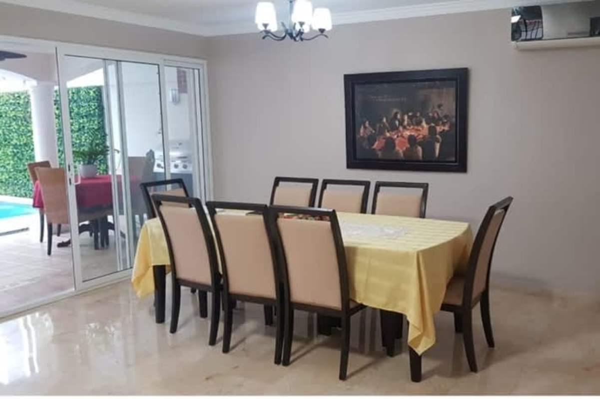 Spacious formal dining room with marble floor and pool view in La Alameda Betania